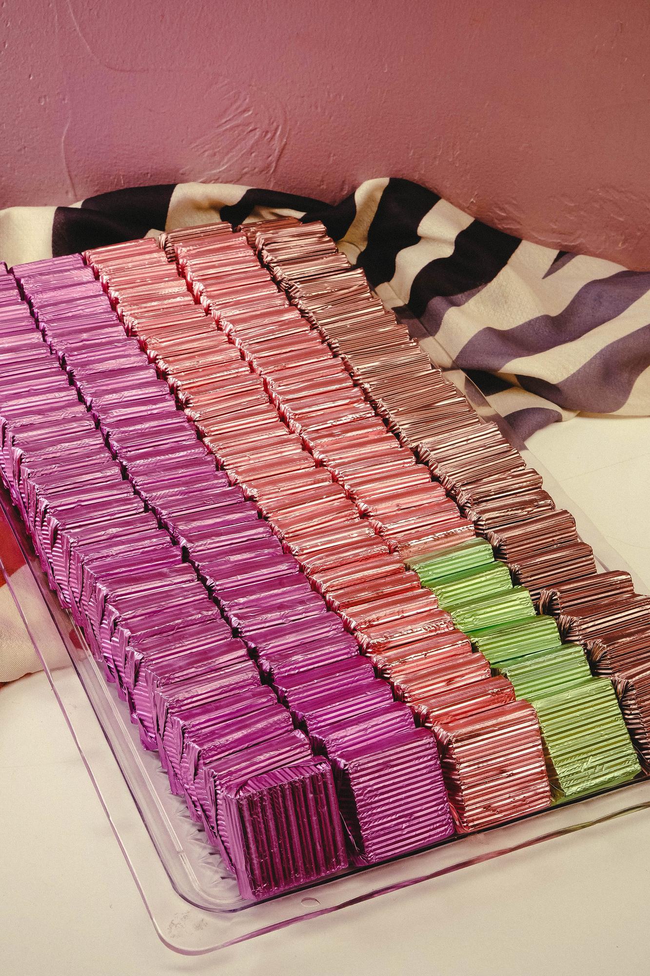 stacked fabric swatches and thread spools